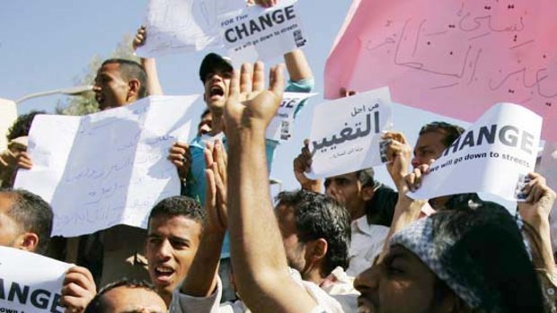 Anti-government protesters shout slogans during a protest outside Sanaa University.