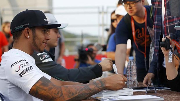 Lewis Hamilton signs autographs for fans at the Korean Grand Prix.