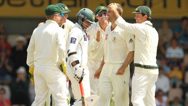 Man of the moment . . . Australia's Simon Katich is congratulated by his team mates after taking the wicket of Salman Butt of Pakistan during day three of the Third Test match between Australia and Pakistan at Bellerive Oval.