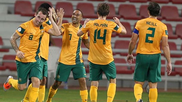 Oh yeah: Archie Thompson celebrates after scoring a goal against Iraq.