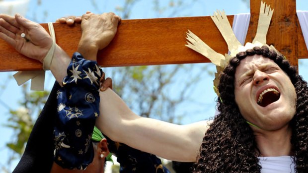 John Safran, identifying himself as John Michael, has his hands nailed to the cross in imitation of Christ's death as part of Good Friday rituals in the Philippines, on Friday.