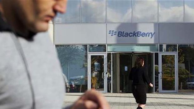 A woman walks outside Research In Motion's headquarters in Slough, southern England in October, 2011.