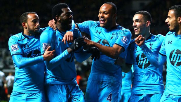 Double trouble: Tottenham's Emmanuel Adebayor (second from left) celebrates his second goal against Newcastle.