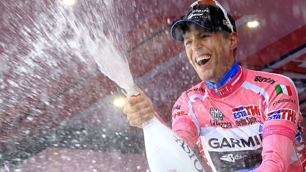 Garmin's Ryder Hesjedal of Canada, wearing the leader's pink jersey, celebrates on the podium after the 206-kilometre 14th stage of the Giro d'Italia.