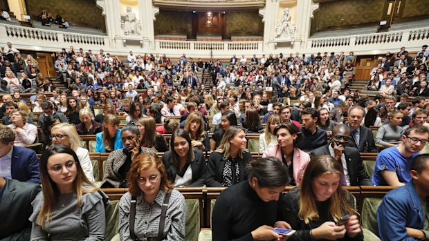 Members of the audience are pictured prior to the start of the French President's speech at the Sorbonne.
