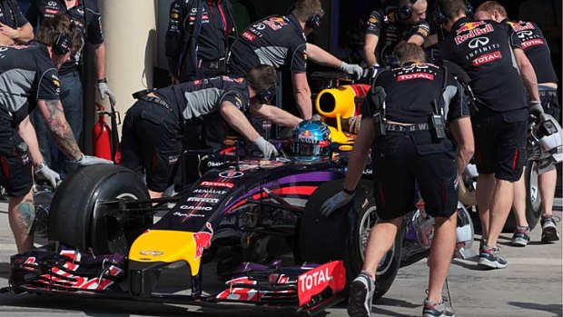 Sebastian Vettel of Red Bull Racing, is pushed into the garage during testing at the Bahrain International Circuit in Sakhir.