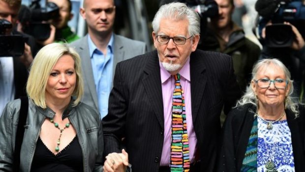 Rolf Harris arrives with his wife Alwen Hughes, right, and daughter Bindi, left, at court on May 12.