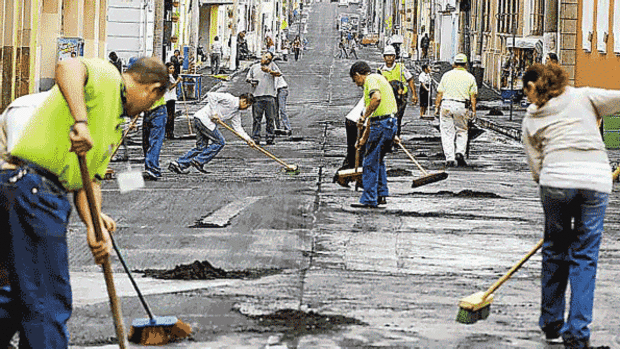 Residents sweep ash off the streets in Guatemala City a day after the Pacaya volcano erupted.