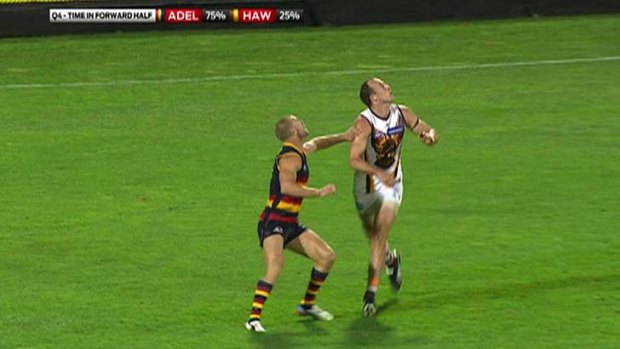 Feather touch ... Adelaide's Scott Thompson was penalised for a slight touch on Hawthorn's David Hale.