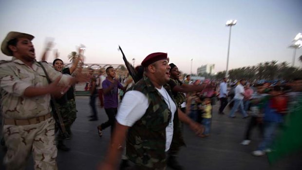 Libyan National Transitional Council fighters parade in Tripoli as fierce clashes erupted in Bani Walid.