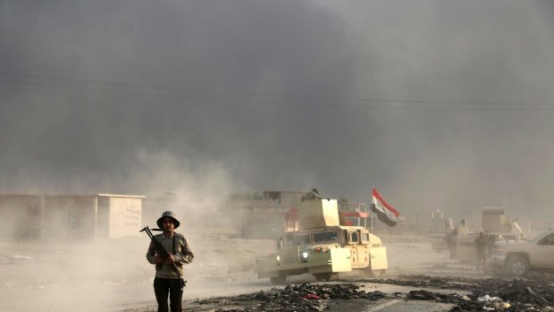 Iraqi soldiers are seen outside the city of Mosul on Wednesday.