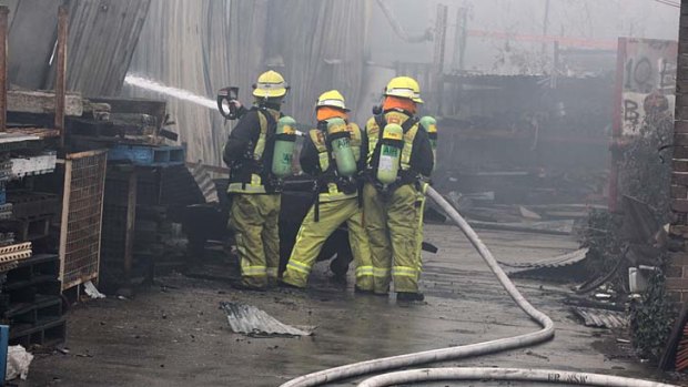 Firefighters battle the furniture factory fire.