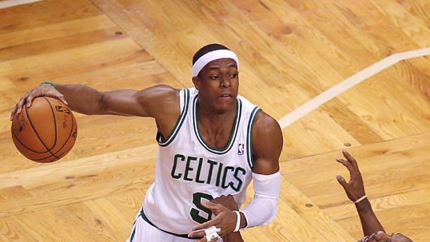 Boston Celtics' Rajon Rondo picks up an offensive foul against Miami Heat's Mario Chalmers.