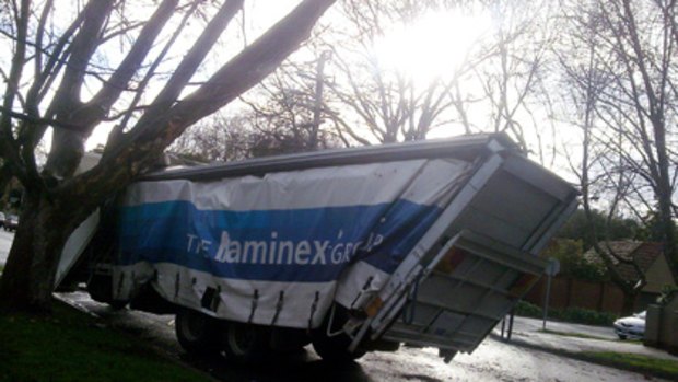 The Laminex-branded truck sits wedged under a tree on Orrong Road, Prahran.