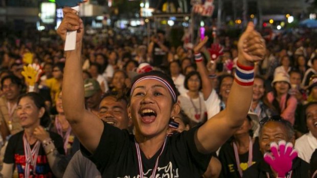 Anti-government protesters cheer during the first day of a mass demonstration at a downtown intersection in Bangkok, Thailand. 
