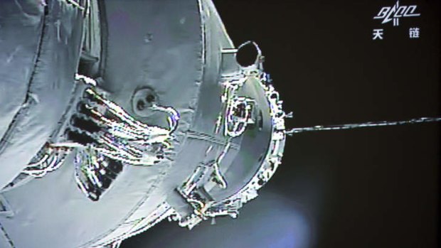 In this image made off the screen at the Beijing Aerospace Control Center and released by China's Xinhua News Agency, the Shenzhou-10 manned spacecraft is seen while conducting docking with the orbiting Tiangong-1 space module Thursday, June 13, 2013.