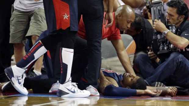 Horrific: Paul George lies on the court after suffering the badly broken leg.