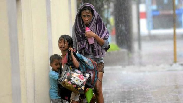 A mother takes refuge with her children as Typhoon Haiyan hits Cebu city.