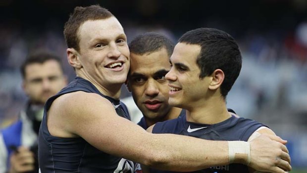 Blues Mitch Robinson, Chris Yarran and Jeff Garlett celebrate their win over the Bombers yesterday.