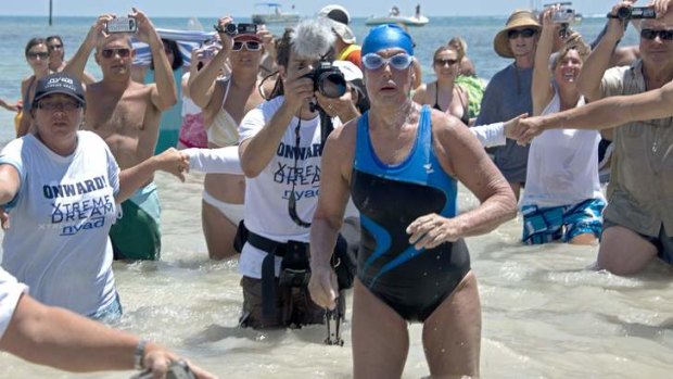 Diana Nyad emerges from the Atlantic Ocean after completing a 180-kilometre swim from Cuba to Key West, Florida.