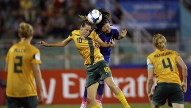 Australia's Emily van Egmond battles for the ball with Japan's Yumi Kawamura.