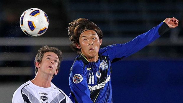 Heads up: Victory's Robbie Kruse and Takashi Usami in last night's clash.