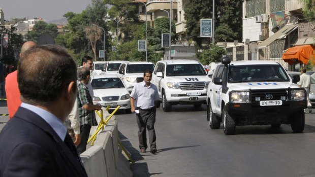 A convoy of United Nations vehicles carrying chemical weapons experts leaves a hotel in the Syrian capital Damascus on Sunday.