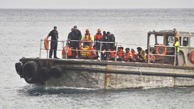 A barge carrying rescued suspected asylum seekers nears Christmas Island in June.
