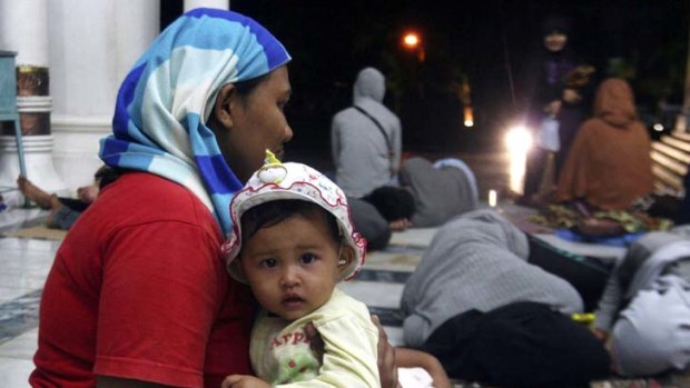 Relief &#8230; women and children take refuge in a mosque as the quake hit Aceh on Wednesday.