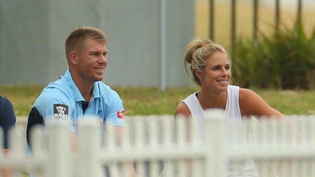White picket fence: Warner and girlfriend Candice Falzon.