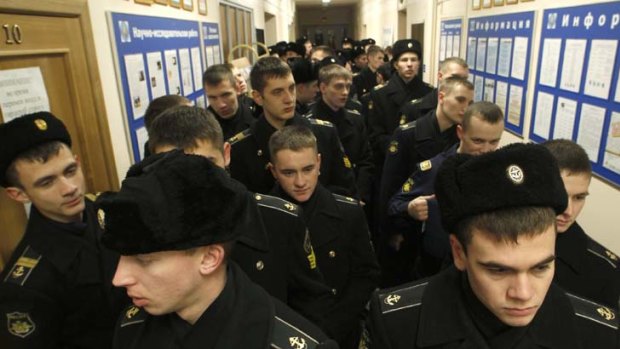 Uniform suspicion ... soldiers queue to vote in Vladivostok as observers question the scale of interference by authorities in the parliamentary elections for the Duma.