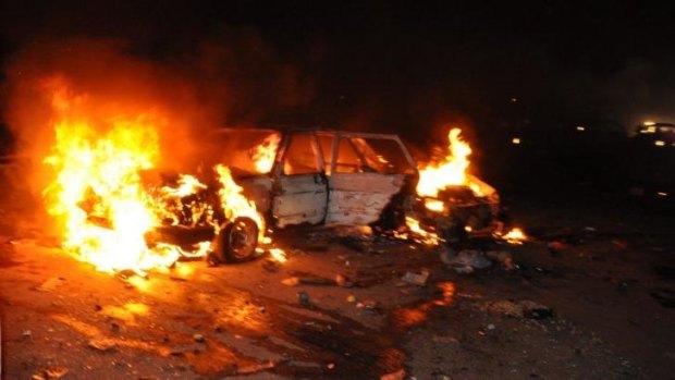 A car burns following a bomb explosion in Abuja on Thursday.