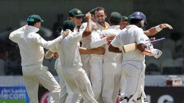 Howzat! &#8230; Nathan Lyon is mobbed after taking a wicket with his first ball in Test cricket.