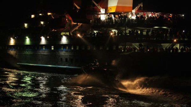 INTERNATIONAL WATERS ...  activists look on as Israeli boats close in on the Mavi Marmara.
