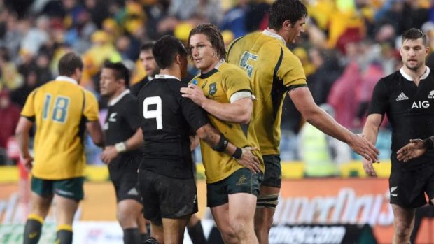Points shared: Wallabies captain Michael Hooper shakes hands with All Blacks scrum-half Aaron Smith after the drawn game.