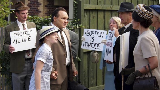 Irony? ... Bert Wainer confronted by abortion protesters in a scene from <i>Dangerous Remedy.</i>