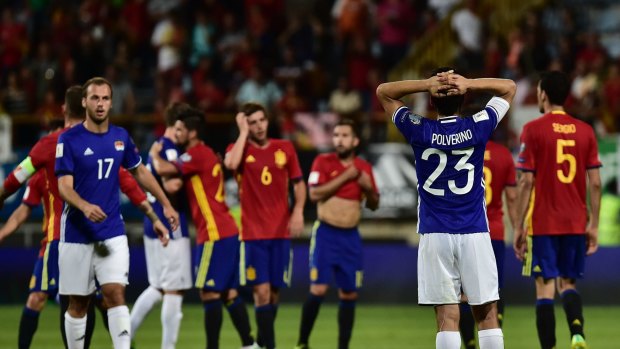 Liechtenstein's Michele Polverino, right, laments at the end of the match against Spain during their World Cup Group G qualifying soccer match at the Reino de Leon Stadium, in Leon, northern Spain, Monday Sept. 5, 2016. Spain won the match 8-0. (AP Photo/Alvaro Barrientos)