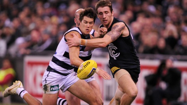 Geelong's Andrew Mackie battles with Carlton's Zach Tuohy.