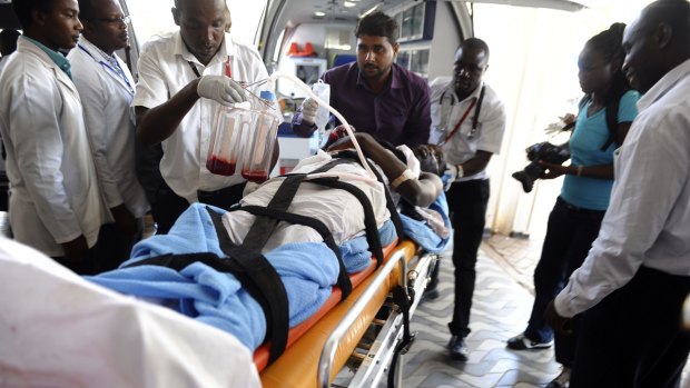 Medics help an injured person at Kenyatta national Hospital in Nairobi, Kenya, after being airlifted from Garissa.