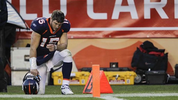 "Tebowing"... the quarterback shows off his trademarked gesture while playing for former club the Denver Broncos.