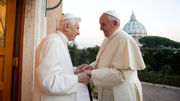 Pope Emeritus Benedict XVI, left, and Pope Francis  exchange Christmas greetings at the Vatican.