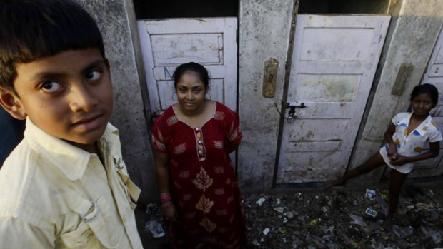 Shah Rukh Munshi, 11 (left), who acted in  Slumdog Millionaire  and his mother, Regina Munshi, 28, near their slum home.