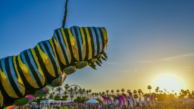 A giant caterpiller hovers over the crowd at Coachella.