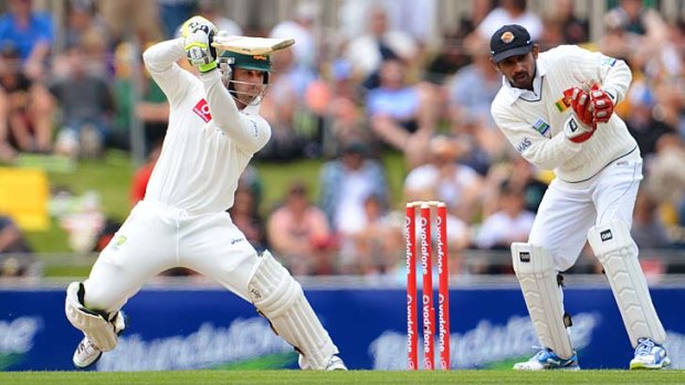 Watertight &#8230; Phillip Hughes cuts a ball as Sri Lankan wicketkeeper Prasanna Jayawardene looks on at Hobart on Friday.