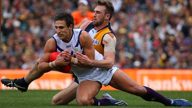 On the spot: Matthew Pavlich takes a mark against Eagle Eric Mackenzie.