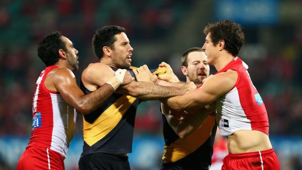 Tensions rise: Troy Chaplin of the Tigers and Kurt Tippett of the Swans exchange words.
