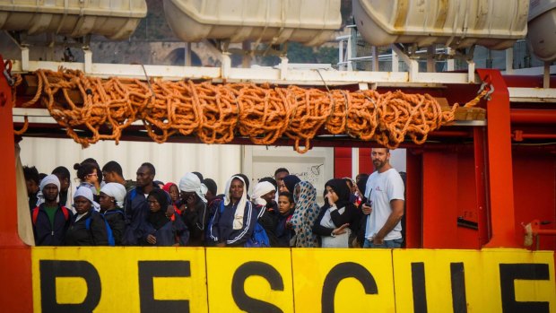 Migrants wait to disembark from Medecins Sans Frontier Vos Prudence ship after being rescued at sea, at Salerno's harbour, Italy on Friday.
