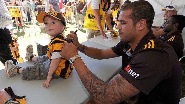 Signature move: Hawthorn forward Lance Franklin puts a smile on a young face at family day on Sunday.