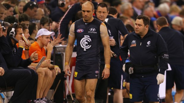 Carlton's Chris Judd leaves the field injured during the clash against the Western Bulldogs.