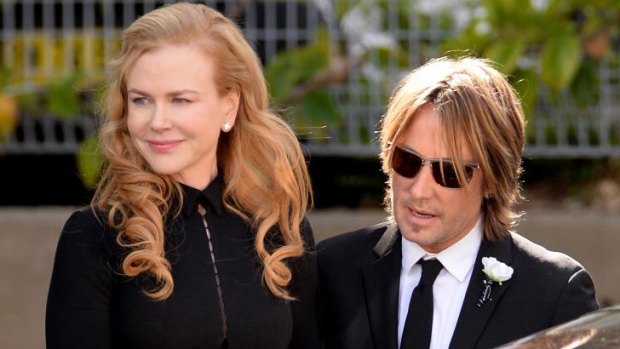 Putting on a brave face: Nicole Kidman and Keith Urban arrive at the funeral service for her father Antony.